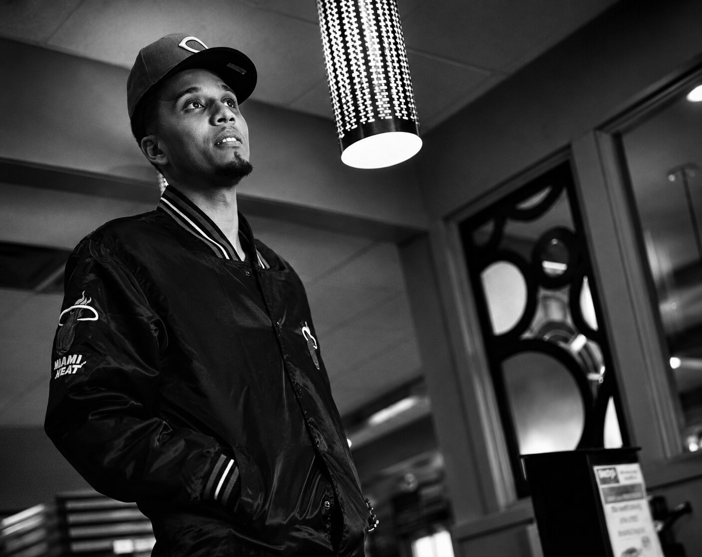 Thello Jay — black-and-white editorial portrait wearing a fitted cap