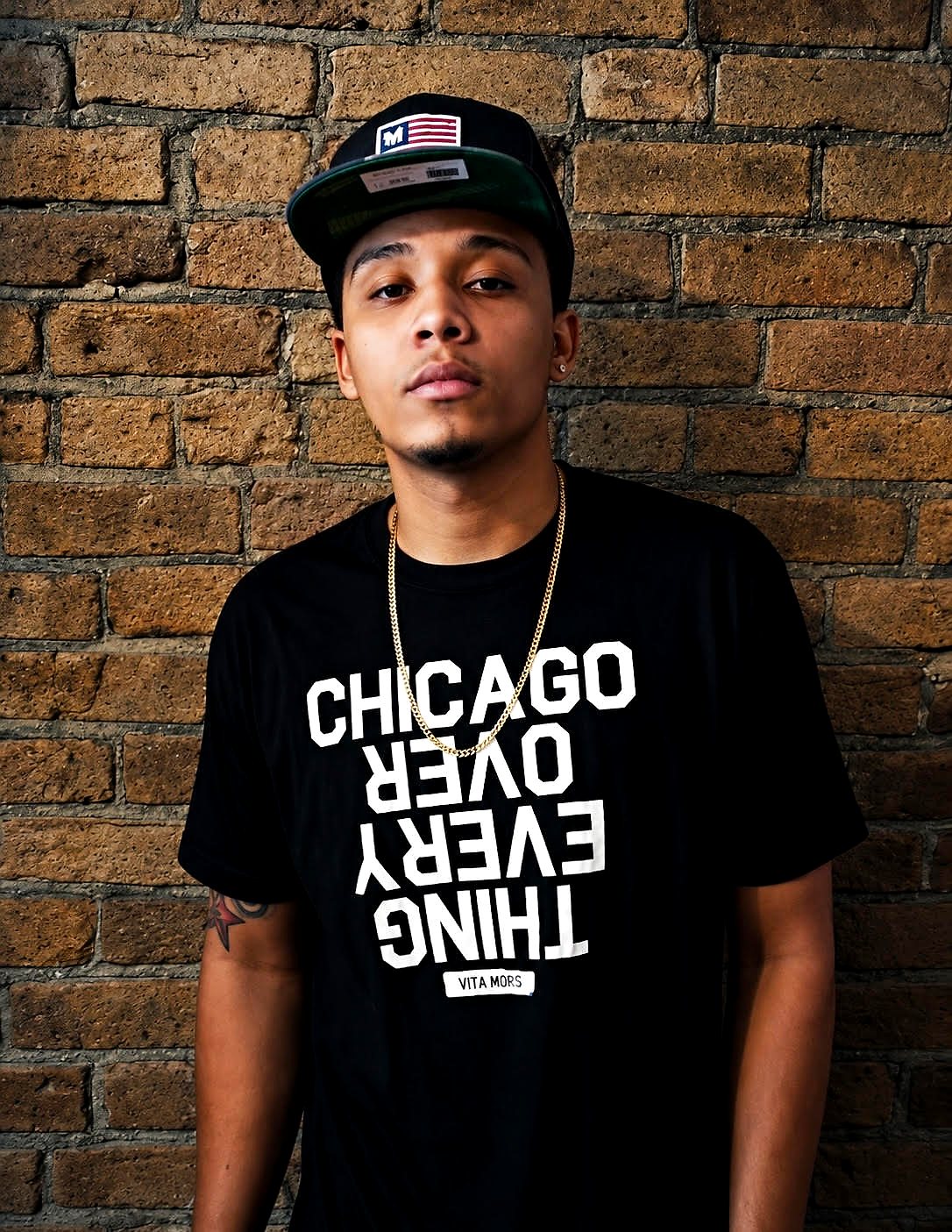 Thello Jay against a Chicago brick wall during the His Era photoshoot